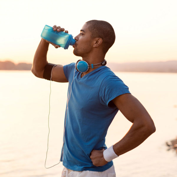 Athlete stopping to drink immune beverage