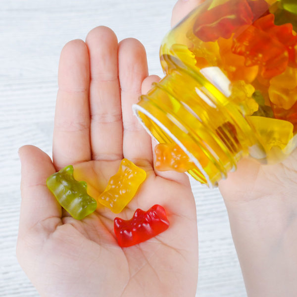 Gummy vitamins poured into a hand