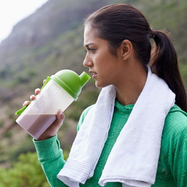 Athlete drinking protein shake outside